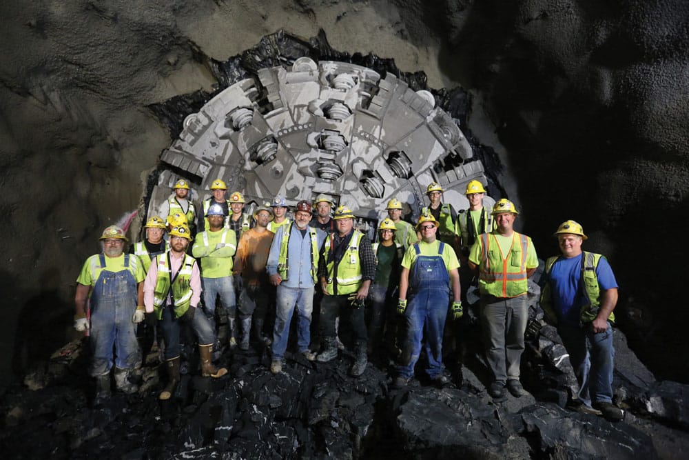Robbins project team at tunnel breakthrough